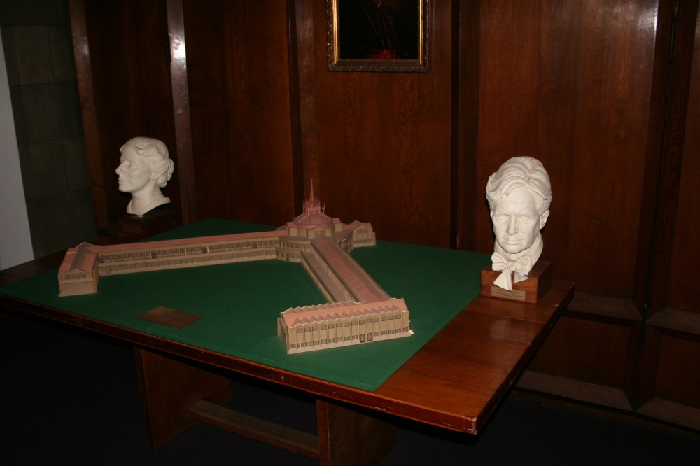 Busts of Marion Mahony Griffin and Walter Burley Griffin, along with their model of the college. 